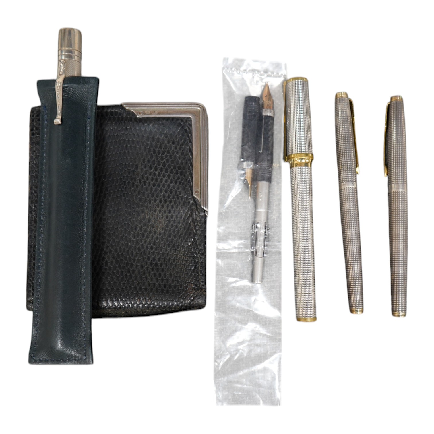 A collection of pens comprising two Sterling Parker fountain pens, one with 14k gold nib, a silver Yard-O-Lead pen, a lizard skin wallet and a Dupont fountain pen. Condition - wallet worn, pens not tested with ink for wo